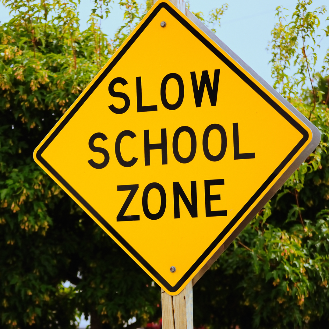 Slow School Zone street sign