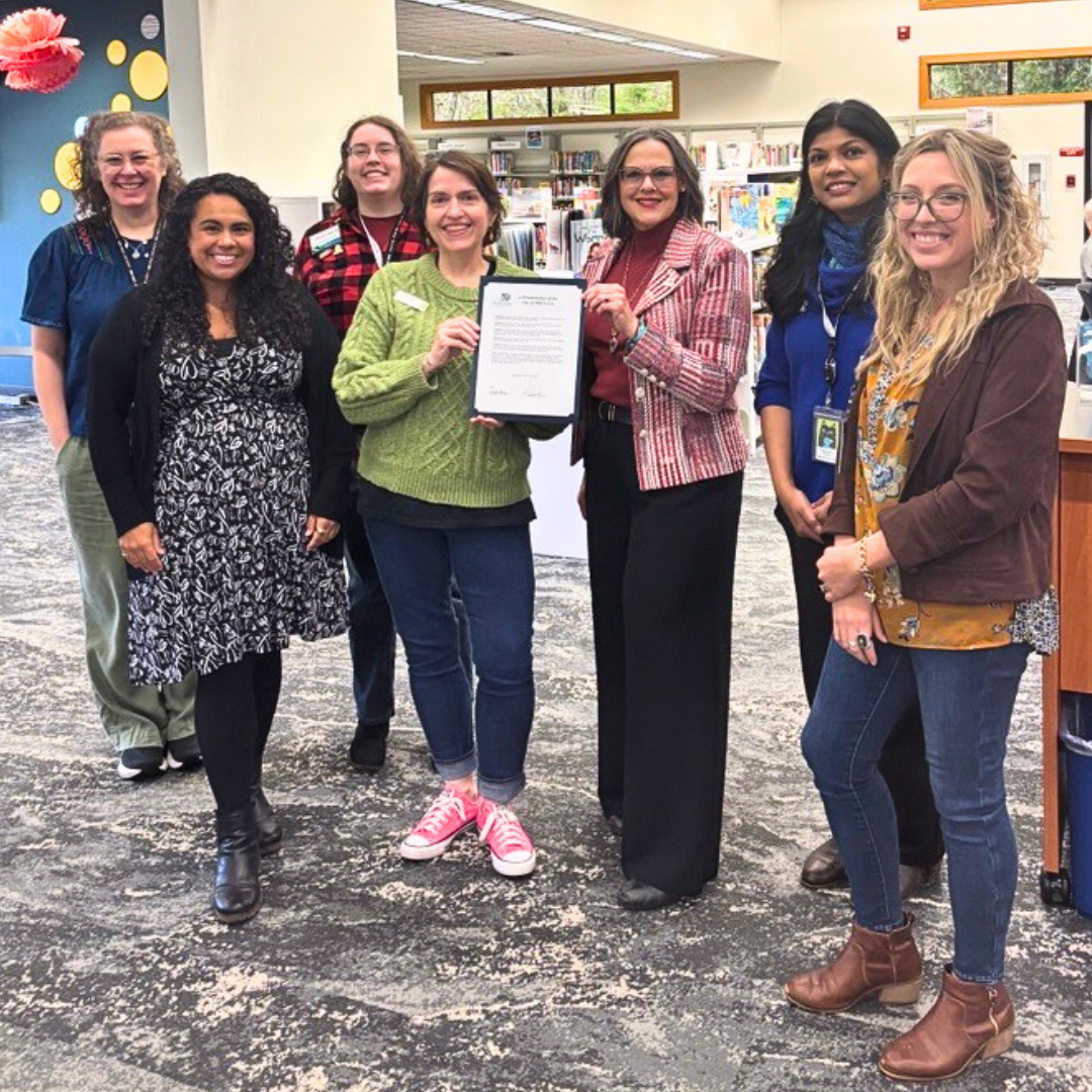 Mayor Stephanie Vignal and Mayor Pro Temp Melissa Duque present the City of Mill Creek National Library Week proclamation to Sno-Isle staff.