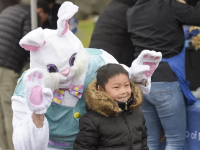 The Easter Bunny poses for a photo with a child