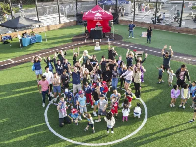 Community members assemble for a group photo at Party in the Parks