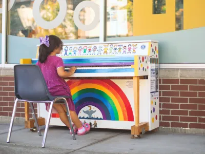 Pianos on Main in Mill Creek Town Center with a child sitting down to play a brightly painted piano.
