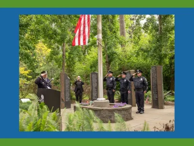 Police officers saluting at Veterans Monument