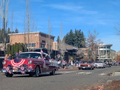 Veterans Day Parade with a line of classic cars down Main St.