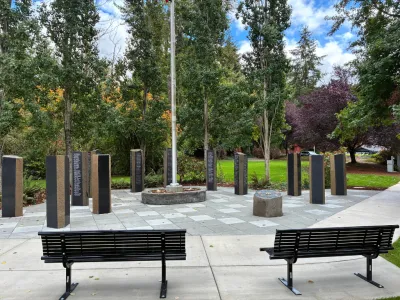 Veterans Monument at Library Park showing new monument pillars, a flagpole, and newly installed benches.
